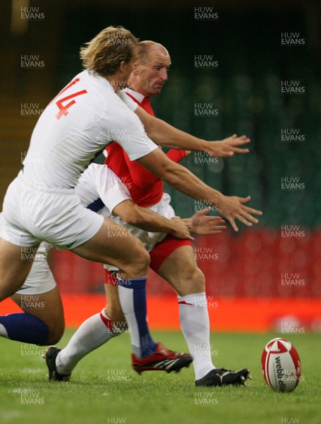 26.08.07  Wales v France... Wales Gareth Thomas tries to kick past Aurelien Rougerie 