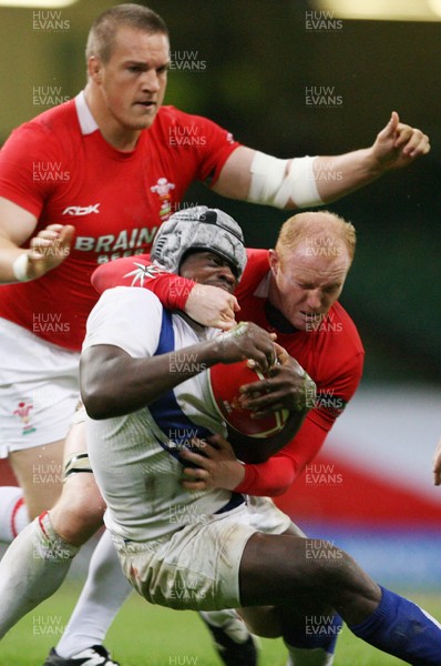 26.08.07  Wales v France... France's Serge Betsen feels the force of a Martyn Williams tackle. 
