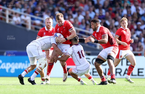 071023 - Wales v Georgia - Rugby World Cup, France 2023 - Pool C - Nick Tompkins of Wales is tackled by Mikheil Gachechiladze and Luka Matkava of Georgia 