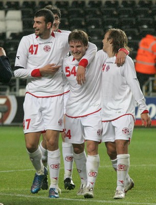 20.08.08 Wales vs. Georgia. Nationwide International Friendly. The Liberty Stadium, Swansea. Goal scorer Beka Gotsiridze(C) is congratulated by team-mates Aleksandre Kvakhadze(47) & Irakli Klimiashvili(24) following his injury time winner to edge out Wales 1-2. 
