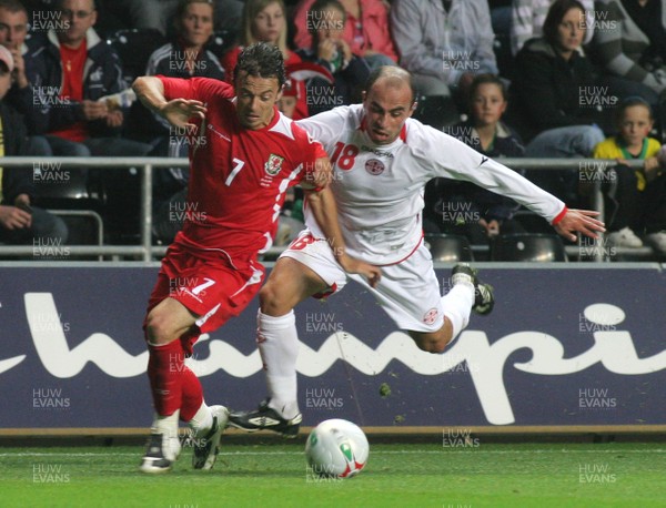20.08.08 Wales vs. Georgia. Nationwide International Friendly. The Liberty Stadium, Swansea. Wales captain Simon Davies outpaces Zurab Menteshashvili in a chase for the ball. 