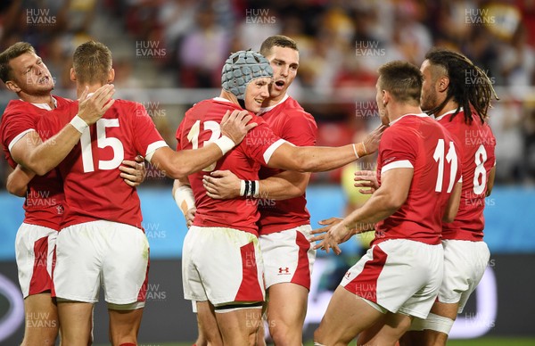 230919 - Wales v Georgia - Rugby World Cup 2019 - Pool D - Jonathan Davies celebrates with George North of Wales and team mates after scoring a try