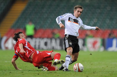 01.04.09 - Wales v Germany - 2010 FIFA World Cup Qualifying Group 4 - Germany's Philipp Lahm is tackled by Simon Davies. 