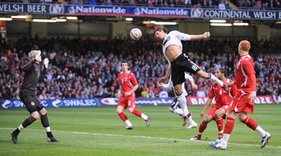 01.04.09 - Wales v Germany - World Cup 2010 - Qualifying Group 4 Germany's Mario Gomez heads toward Wales 'keeper Wayne Hennessey 