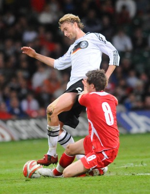 01.04.09 - Wales v Germany - World Cup 2010 - Qualifying Group 4 Germany's Simon Rolfes is tackled by Wales' Aaron Ramsey 