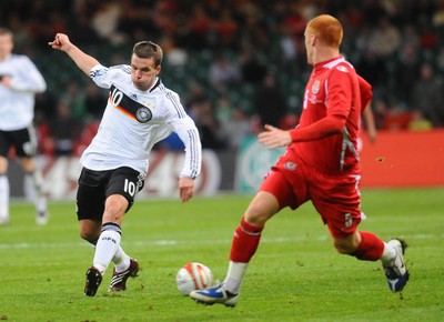 01.04.09 - Wales v Germany - World Cup 2010 - Qualifying Group 4 Germany's Lukas Podolski looks for a way past Wales' James Collins 