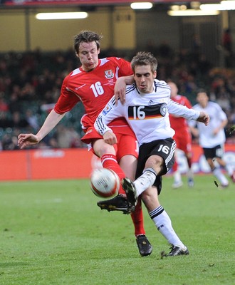 01.04.09 - Wales v Germany - World Cup 2010 - Qualifying Group 4 Wales' Chris Gunther and Germany's Philipp Lahm compete 