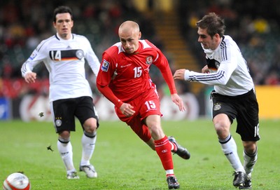 01.04.09 - Wales v Germany - World Cup 2010 - Qualifying Group 4 Wales' David Cotterill past Germany's Piotr Trochowski and is challenged by Philipp Lahm 
