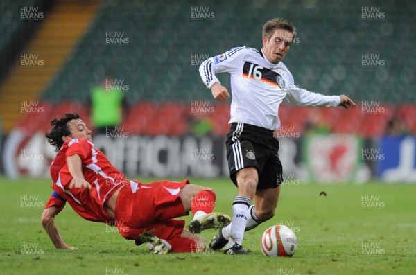 01.04.09 - Wales v Germany - 2010 FIFA World Cup Qualifying Group 4 - Germany's Philipp Lahm is tackled by Simon Davies. 