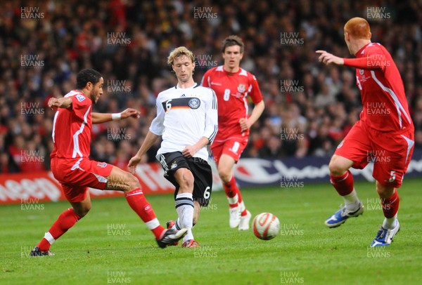 01.04.09 - Wales v Germany - World Cup 2010 - Qualifying Group 4 Germany's Simon Rolfes looks to get past Wales' Ashley Williams (L) and James Collins (R) as Aaron Ramsey looks on 