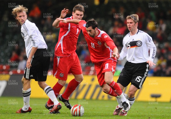 01.04.09 - Wales v Germany - World Cup 2010 - Qualifying Group 4 Wales' Joe Ledley is challenged by Germany's Simon Rolfes (L) and Thomas Hitzlsperger as Wales' Sam Vokes looks on 