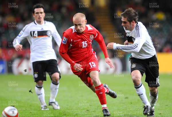 01.04.09 - Wales v Germany - World Cup 2010 - Qualifying Group 4 Wales' David Cotterill past Germany's Piotr Trochowski and is challenged by Philipp Lahm 