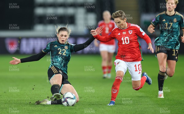 051223  - Wales v Germany, UEFA Women’s Nations League - Jule Brand of Germany clears the ball as Jess Fishlock of Wales closes in