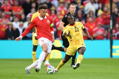 020626 - Wales v Ghana - International Friendly - Ethan Ampadu of Wales is challenged by Kamaldeen Sulemana of Ghana