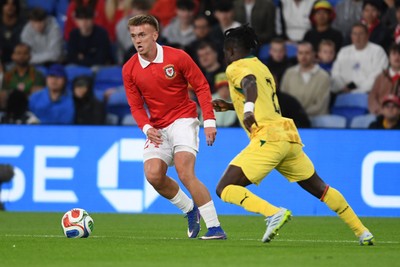020626 - Wales v Ghana - International Friendly - Isaak Davies of Wales is challenged by Alidu Seidu of Ghana