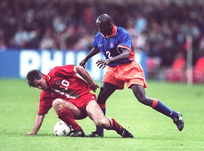 051096 - Wales v Holland - Mark Hughes of Wales is tackled by Ferdi Vierklau