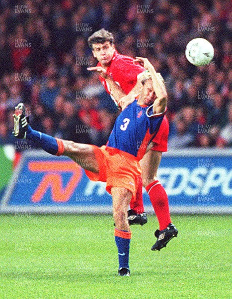 051096 - Wales v Holland - Mark Hughes of Wales climbs above Stan Valckx