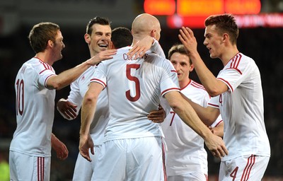 050314 - Wales v Iceland - Friendly -James Collins of Wales celebrates his goal with Gareth Bale (2nd from left)