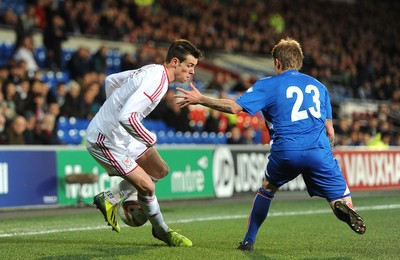 050314 - Wales v Iceland - Friendly -Gareth Bale of Wales is challenged by Ari Skulason of Iceland