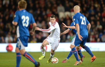 050314 - Wales v Iceland - Friendly -Gareth Bale of Wales and Emil Hallfredsson of Iceland compete