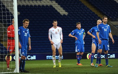 050314 - Wales v Iceland - Friendly -Gareth Bale of Wales looks on in front of rows of empty seats