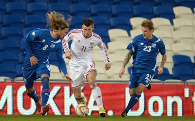 050314 - Wales v Iceland - Friendly -Gareth Bale of Wales tries to get past Birkir Bjarnason and Ari Skulason of Iceland