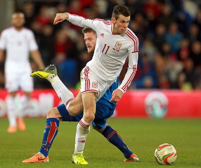050314 - Wales v Iceland - Vauxhall International Friendly - Gareth Bale of Wales gets past Aron Einar Gunnarsson of Iceland 