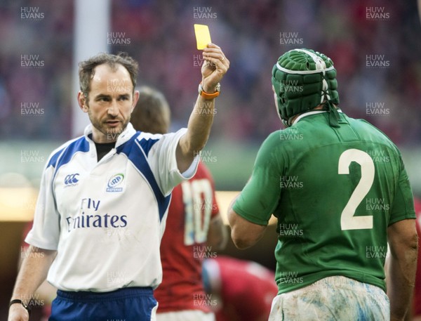 020213 -  Wales v Ireland - RBS 6Nations - Referee Romain Poite shows Ireland's Rory Best a yellow card 