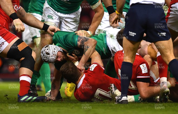 040223 - Wales v Ireland - Guinness Six Nations - Dan Biggar of Wales is held down by Mack Hansen of Ireland as tempers flare