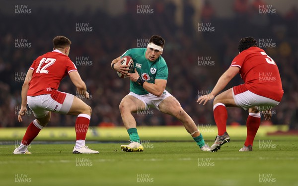 040223 - Wales v Ireland - Guinness Six Nations Championship - Dan Sheehan of Ireland is tackled by Joe Hawkins of Wales