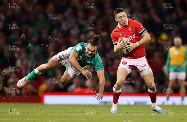 040223 - Wales v Ireland - Guinness Six Nations Championship - Josh Adams of Wales is challenged by James Lowe of Ireland