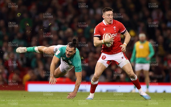 040223 - Wales v Ireland - Guinness Six Nations Championship - Josh Adams of Wales is challenged by James Lowe of Ireland