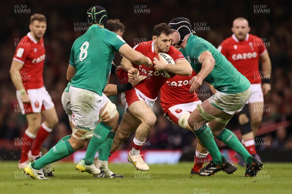 040223 - Wales v Ireland - Guinness Six Nations Championship - Tomos Williams of Wales is tackled by Caelan Doris and James Ryan of Ireland