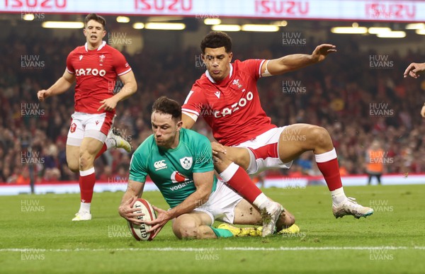 040223 - Wales v Ireland, Guinness Six Nations 2023 - Hugo Keenan of Ireland beats Rio Dyer of Wales to ground the ball