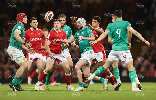 040223 - Wales v Ireland, Guinness Six Nations 2023 - Mack Hansen of Ireland offloads the ball as Rio Dyer of Wales closes in