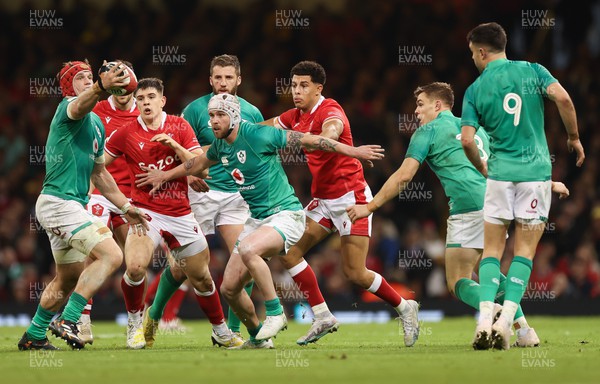 040223 - Wales v Ireland, Guinness Six Nations 2023 - Mack Hansen of Ireland offloads the ball as Rio Dyer of Wales closes in