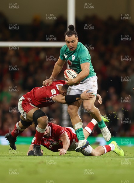 040223 - Wales v Ireland, Guinness Six Nations 2023 - James Lowe of Ireland is tackled by Taulupe Faletau of Wales and Scott Baldwin of Wales