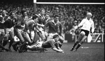 040289 - Wales 13 v 19 Ireland - Five Nations Championship -  Ian Watkins of Wales passes as referee Roger Quittenton watches