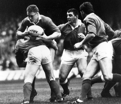 040289 - Wales v Ireland - Five Nations - Mark Jones of Wales is tackled by Phil Matthew of Ireland with support from Rowland Phillips