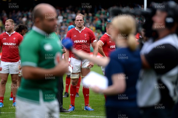 070919 - Ireland v Wales - International Rugby Union - Alun Wyn Jones of Wales looks on as Rory Best of Ireland does a TV interview at the end of the game