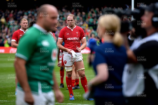 070919 - Ireland v Wales - International Rugby Union - Alun Wyn Jones of Wales looks on as Rory Best of Ireland does a TV interview at the end of the game