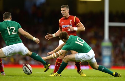 080815 - Wales v Ireland - Dove Men Series 2015 -Scott Williams of Wales kicks past Darren Cave and Paddy Jackson of Ireland