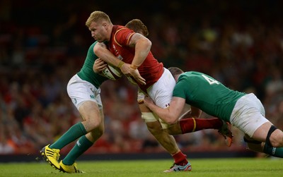 080815 - Wales v Ireland - Dove Men Series 2015 -Ross Moriarty of Wales is tackled by Paddy Jackson and Iain Henderson of Ireland