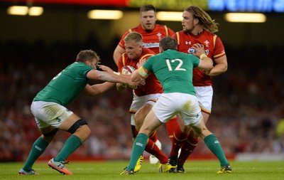 080815 - Wales v Ireland - Dove Men Series 2015 -Gareth Anscombe of Wales is tackled by Jordi Murphy and Darren Cave of Ireland