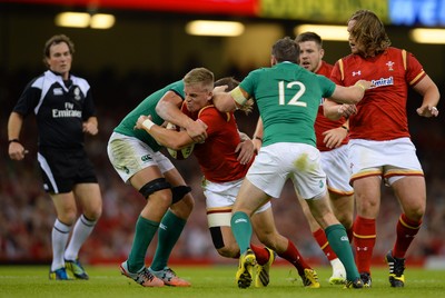 080815 - Wales v Ireland - Dove Men Series 2015 -Gareth Anscombe of Wales is tackled by Jordi Murphy and Darren Cave of Ireland