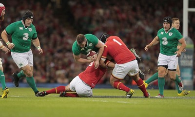 080815 - Wales v Ireland - Dove Mens Series - Iain Henderson of Ireland is tackled by Aaron Jarvis and Nicky Smith of Wales