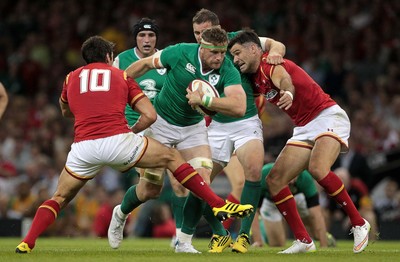 080815 - Wales v Ireland - Dove Mens Series - Jamie Heaslip of Ireland is tackled by James Hook and Mike Phillips of Wales