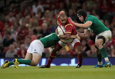 080815 - Wales v Ireland - Dove Mens Series - Eli Walker of Wales is tackled by Paddy Jackson and Tommy O'Donnell of Ireland