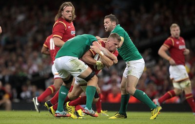 080815 - Wales v Ireland - Dove Mens Series - Gareth Anscombe of Wales is tackled by Jordi Murphy of Ireland