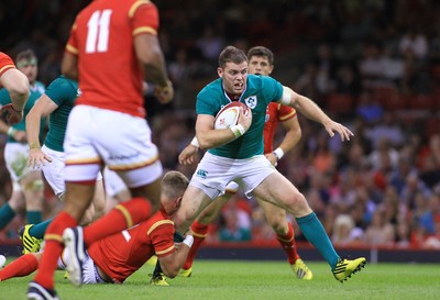 080815 - Wales v Ireland - Dove Men+Care Test - Darren Cave of Ireland is tackled by Gareth Anscombe of Wales